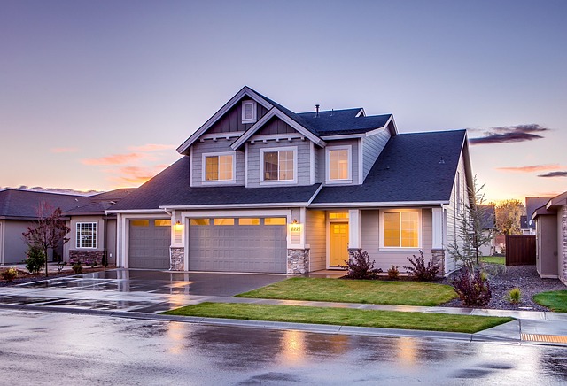 Outside view of a nice, two-story suburban house at twilight after rainfall