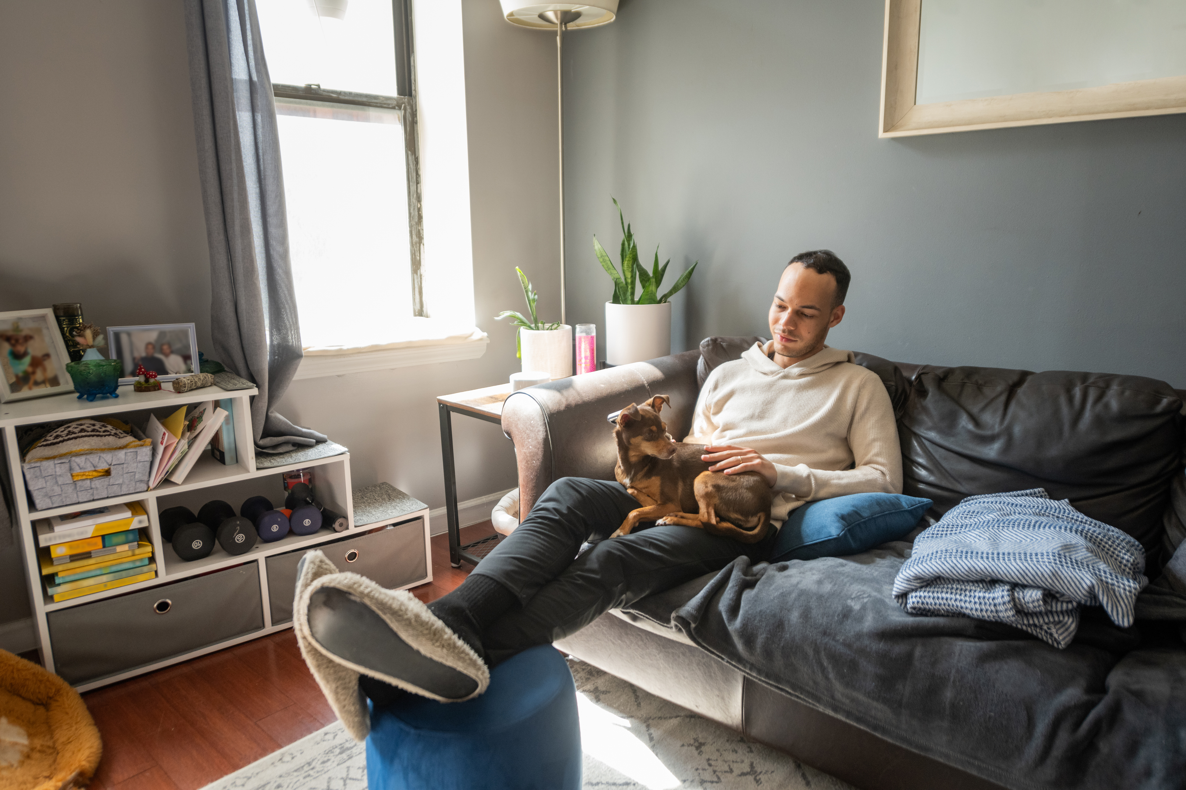 A tenant relaxing in his living room