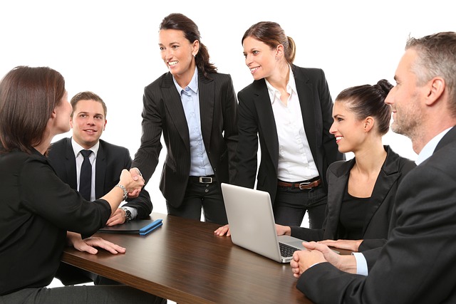 Professional property management team gathered around a table.